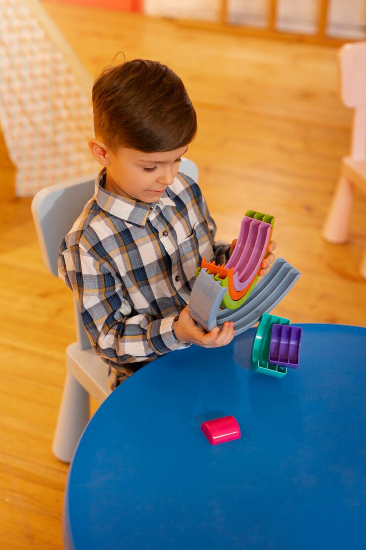 young-boy-playing-indoors-with-eco-toys_23-2150268071